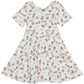 knee length twirl dress with short sleeves and scoop neckline, in soft blue and green watercolor chicks and eggs print on a white background, made of bamboo fabric